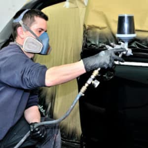 main spray painting a car black