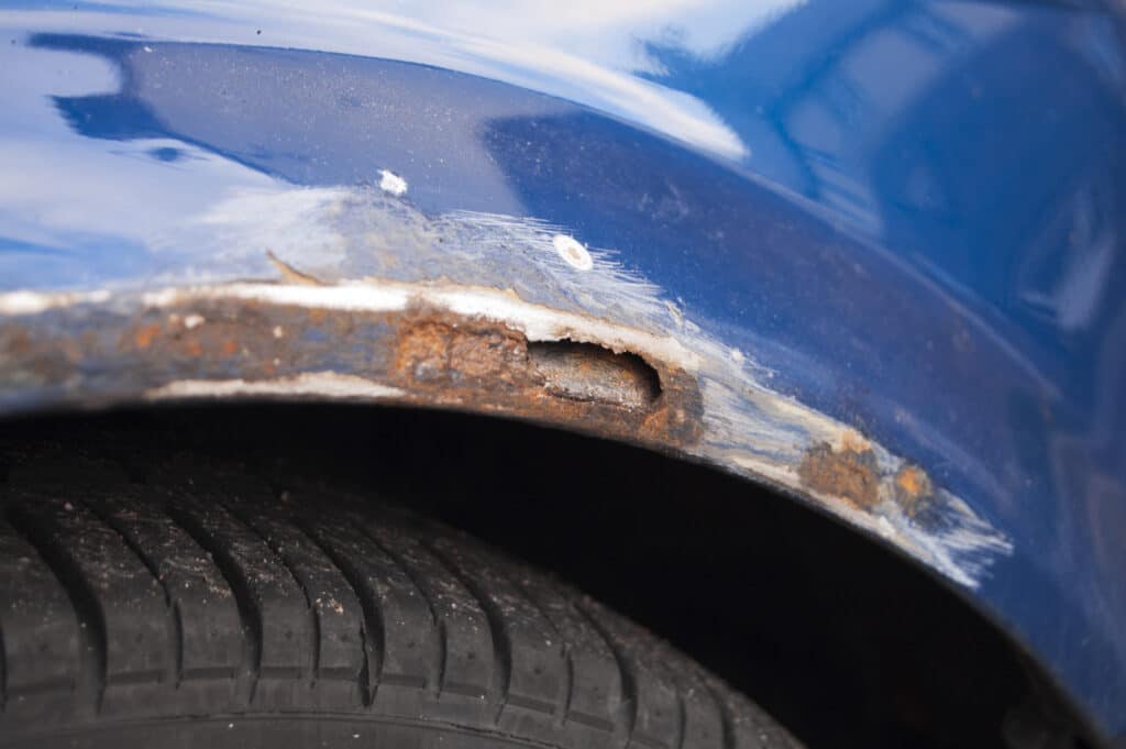 close up of extensive rust damage on a car