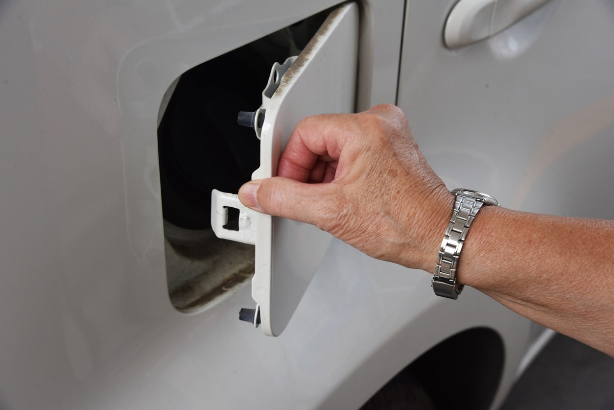 man opening a petrol cap