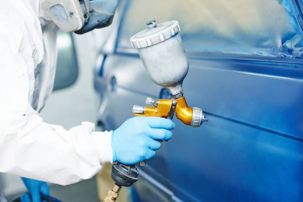 Spraying paint on vehicle 