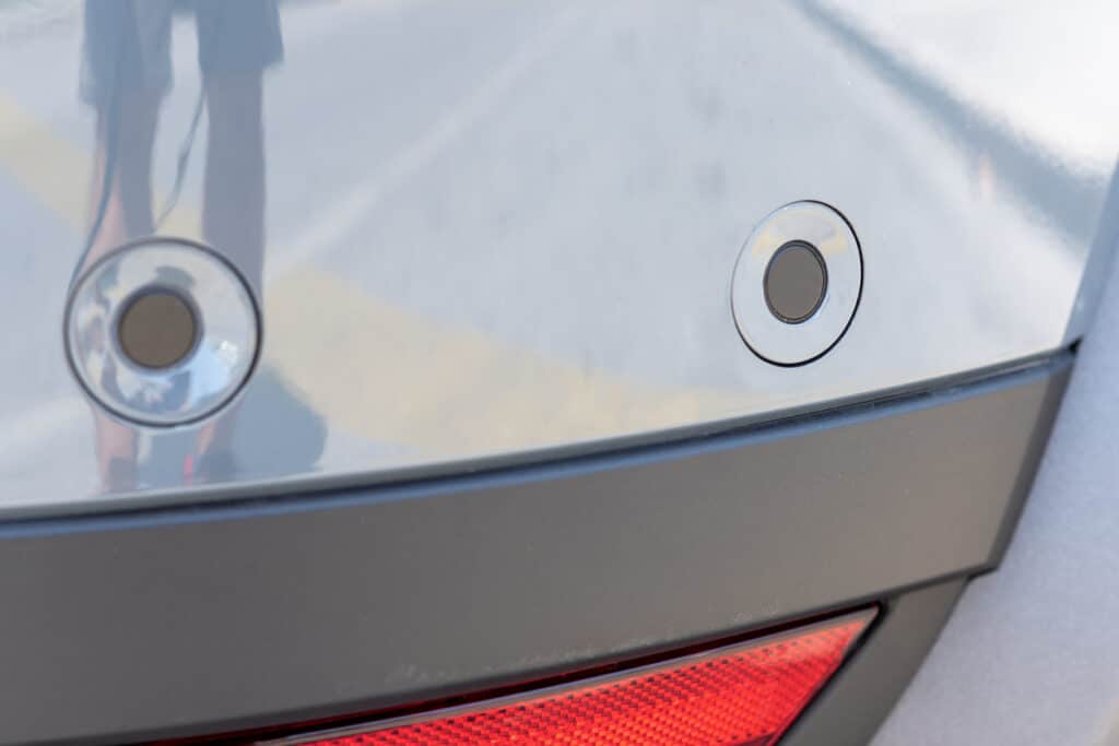 Close up of painted parking sensors on the back of a car