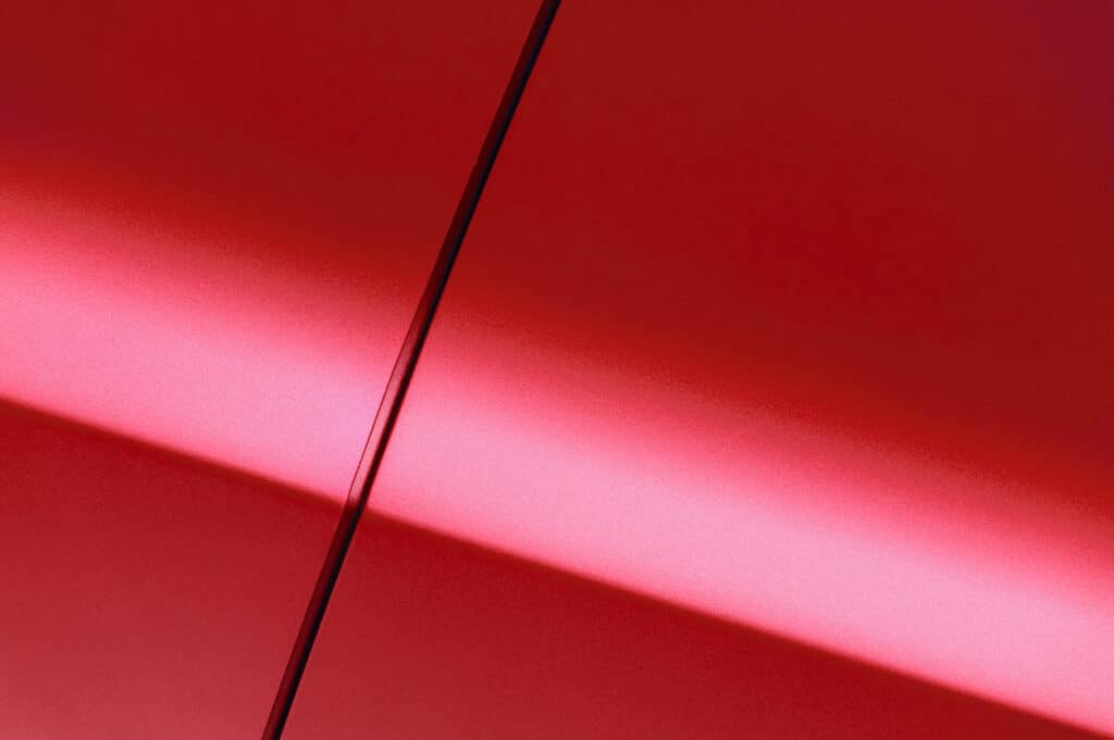 Zoomed in photo of a red car door